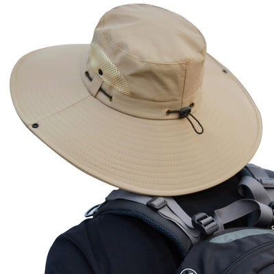 Beige wide-brimmed hat with mesh side on a person wearing a backpack against a white background