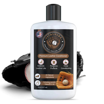 Bottle of leather conditioner with a baseball glove and ball in the background
